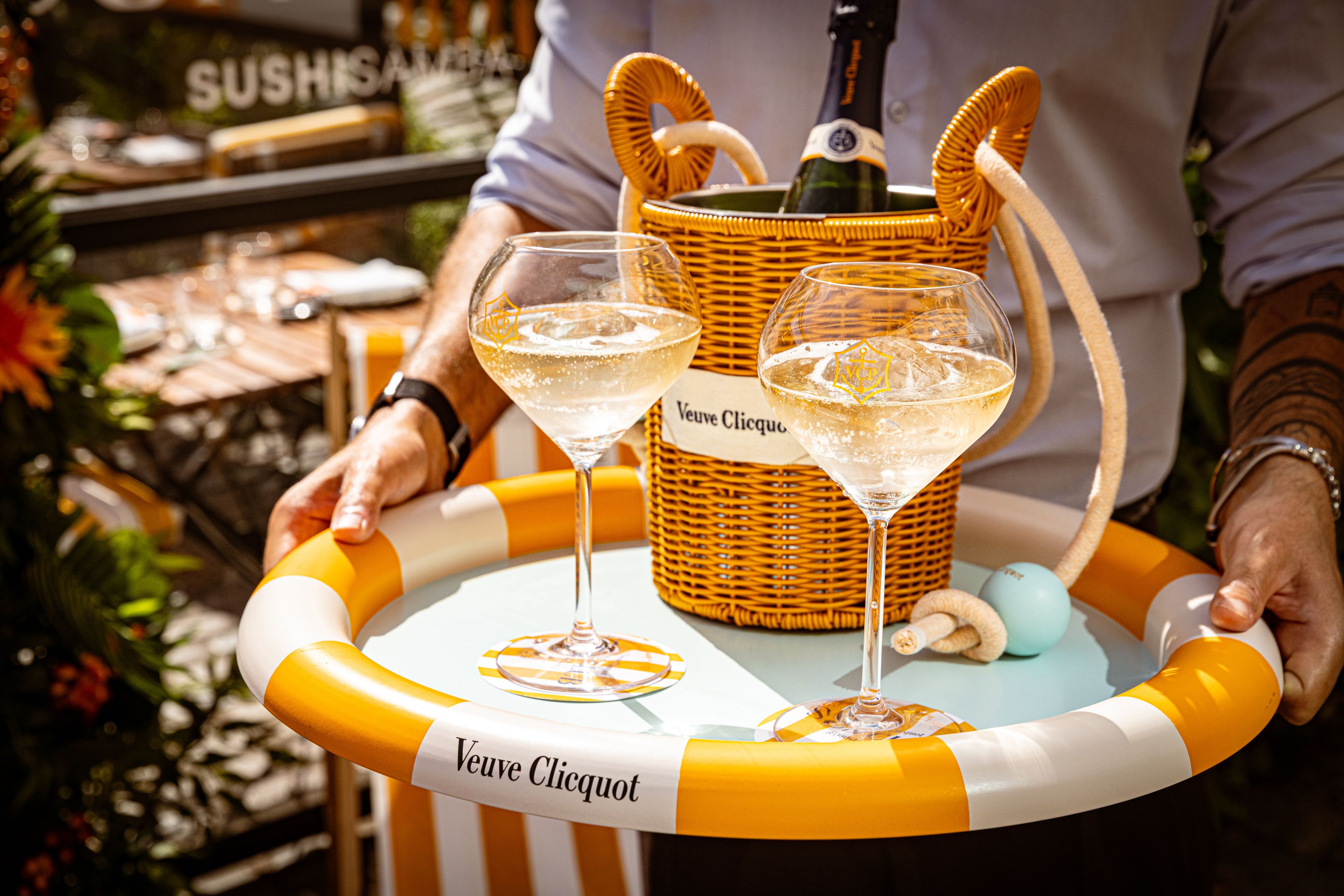 SUSHISAMBA Covent Garden, veuve cliquot sun club terrace with bartender holding drinks