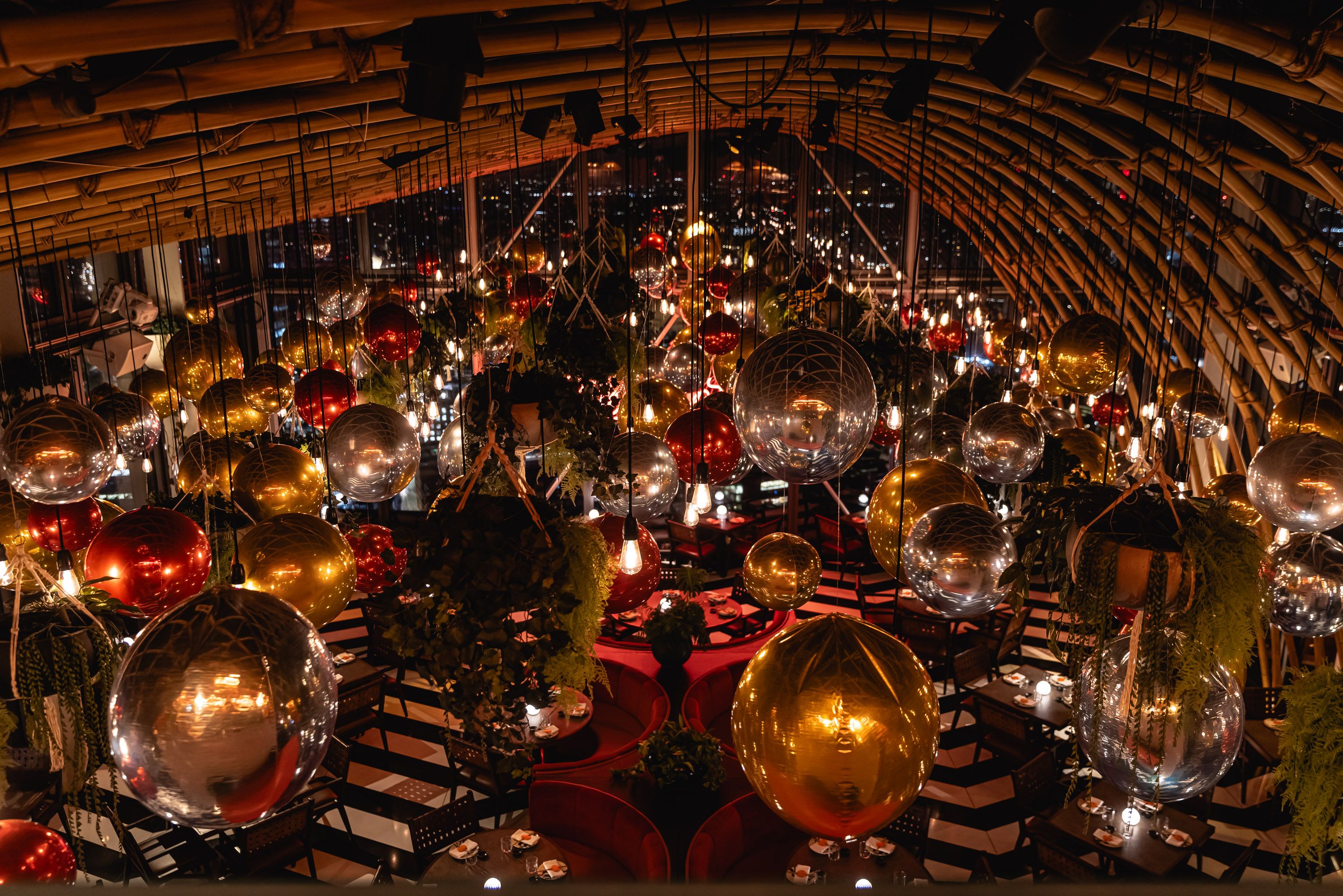 CHRISTMAS DECORATIONS AT SUSHISAMBA HERON TOWER. IMAGE SHOWS FOIL BALLOONS HANGING FROM THE CEILING